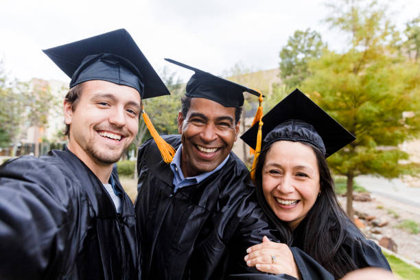 istock Before leaving the campus after graduation, three friends take selfie 1366623784