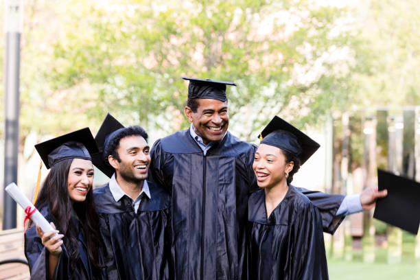 istock Four graduating friends pose for photo 1366623864