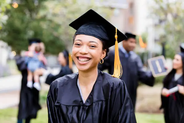 Photo of After graduation ceremony, woman smiles for photo