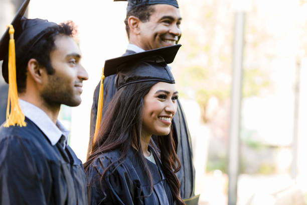 istock Three diverse graduates stand in a row for a photo 1366624108