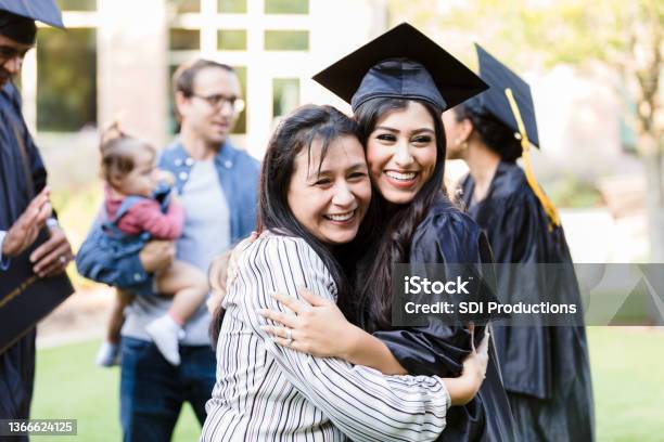 Mother And Graduating Daughter Pose Cheek To Cheek For Photo Stock Photo - Download Image Now