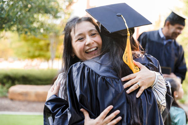 istock College graduate embraces her mother 1366624215