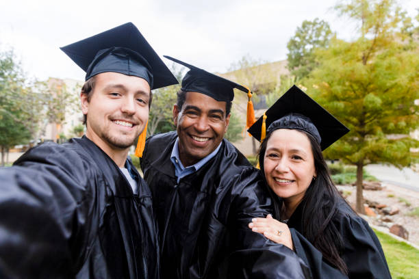 istock College graduates pose for selfie 1366624261