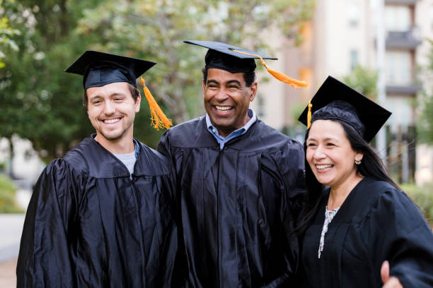 istock Three graduating friends smile happily for camera 1366624333