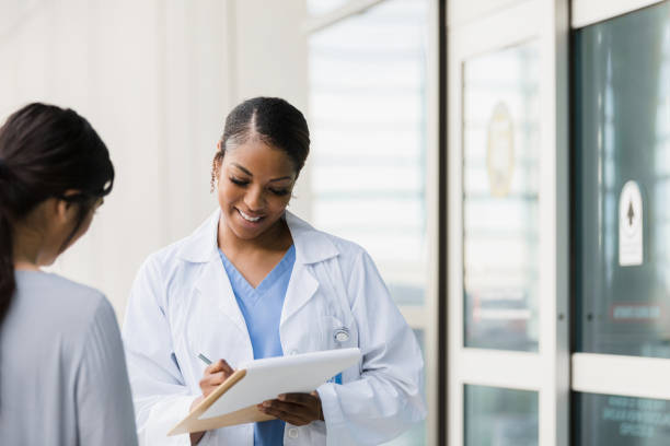 istock Female doctor takes notes as unrecognizable patient speaks 1366626238