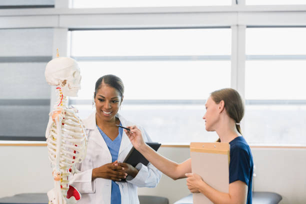 istock Female professor cheerfully listens to question from female student 1366626308