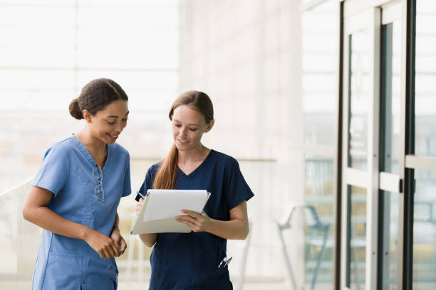 istock Mid adult nursing supervisor trains female student 1366626397