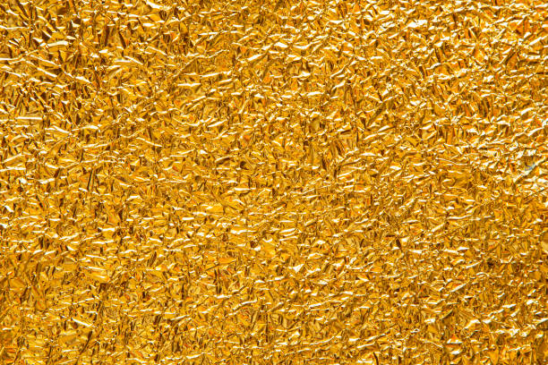 istock Festive background with crumpled golden foil close up texture 1366627086