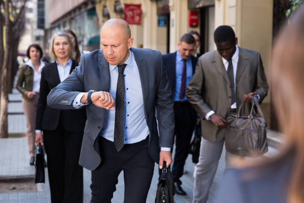 istock Stressed businessman checking time and running 1366627447