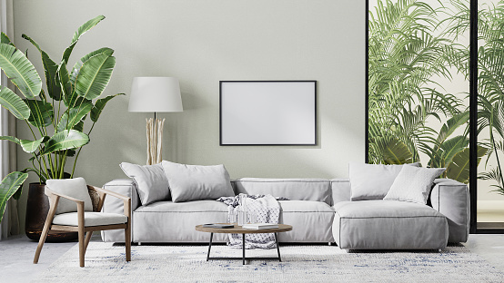 Marco de la imagen en la maqueta interior de la sala de estar en tonos grises con hojas de palmera tropical, renderizado 3D photo