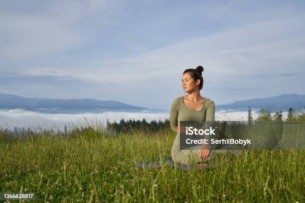 Healthy Woman Doing Fitness Exercises On Yoga Mat Outdoors Stock Photo - Download Image Now