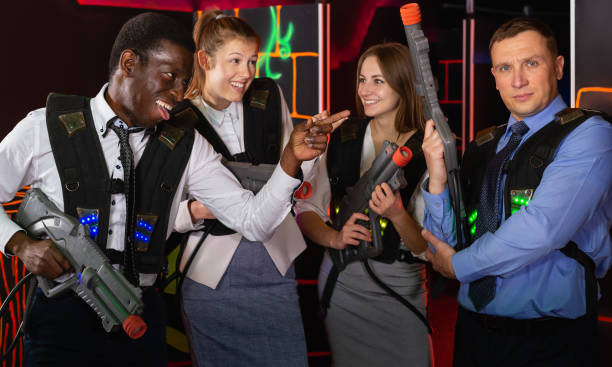 istock Group of young co-workers holding laser guns 1366630218