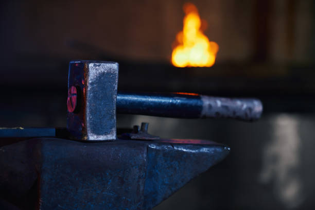 istock Close up of hammer lying on anvil at forge 1366630417
