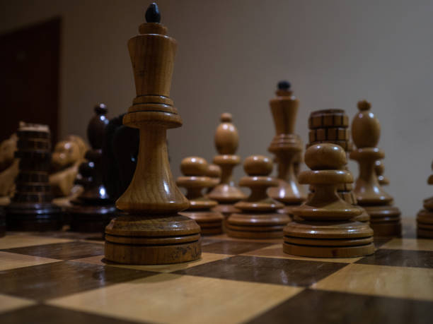 istock Vintage wooden chess on a chessboard, close-up. Intellectual game, 1366630612