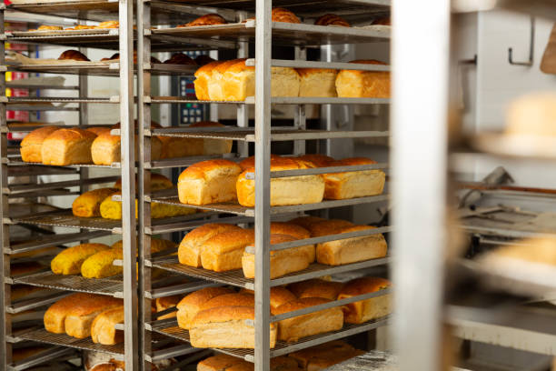 istock Freshly baked bread on trolley in bakery 1366630680