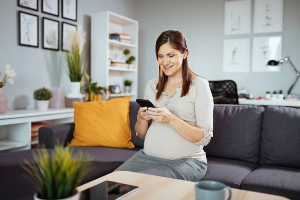 istock Pregnant businesswoman working at home, having video call while working remotely 1366633654