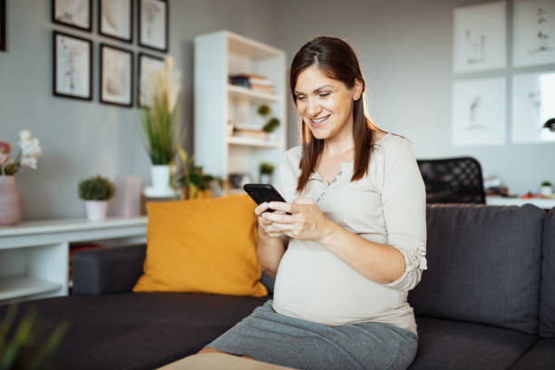 istock Pregnant businesswoman working at home, having video call while working remotely 1366633697