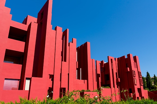 Calpe, Spain - 19 July 2021: The postmodern complex building 'La Muralla Roja', the red wall, by architect Ricardo Bofill