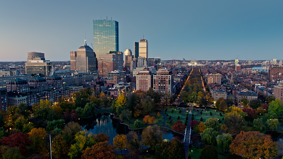 Aerial shot of Boston, Massachusetts, at sunrise, looking across the Public Garden and along Commonwealth Avenue into Back Bay. \n\nAuthorization was obtained from the FAA for this operation in restricted airspace.