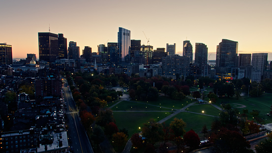Aerial shot of Boston, Massachusetts at sunrise, looking across Boston Common towards the downtown skyline. \n\nAuthorization was obtained from the FAA for this operation in restricted airspace.