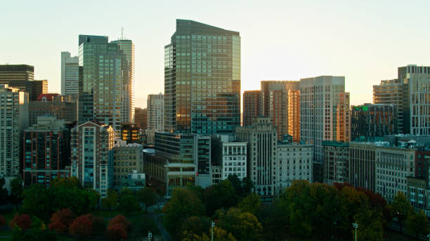 istock Sun Rising Behind Downtown Buildings in Boston, MA - Drone Shot 1366634732