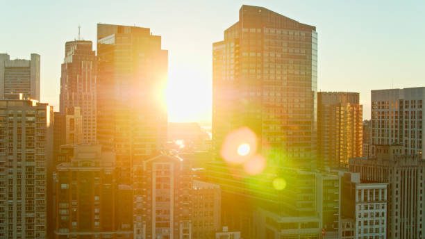 istock Sun Rising Between Downtown Buildings in Boston, MA - Drone Shot 1366634746