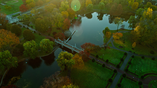 Aerial shot of Boston, Massachusetts at sunrise on a clear morning in Fall, looking down on the Public Garden. \n\nAuthorization was obtained from the FAA for this operation in restricted airspace.