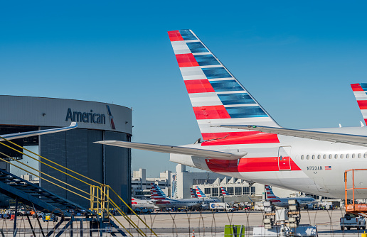 Miami, USA - January 24, 2022: America Airlines planes waiting for passengers at Miami International Airport.