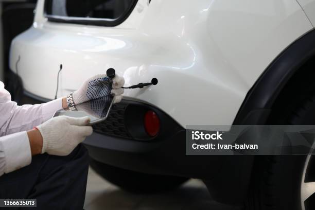 Mechanic Installs Parking Sensors On Car Closeup Stock Photo - Download Image Now - Parking Lot, Sensor, Installing