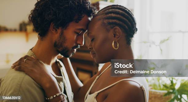 Shot Of A Young Couple Standing Together And Sharing An Intimate Moment At Home Stock Photo - Download Image Now