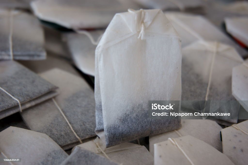 Expired tea bags The photo of expired tea bags represents the concepts of food safety, health risk and poor quality products. Teabag Stock Photo