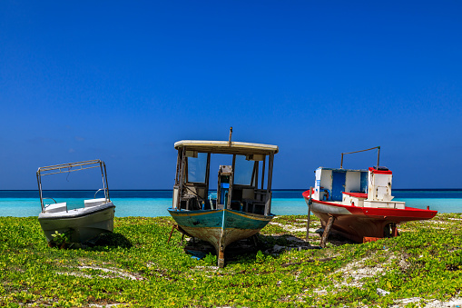 old and rustic fisherman boats on the beach