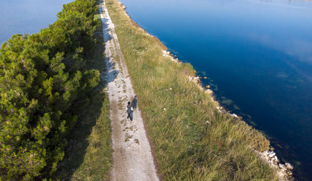 istock little boy walking alone by the sea 1366638073