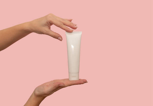 istock Hand holds a white container with cosmetic cream. For body care. 1366640477
