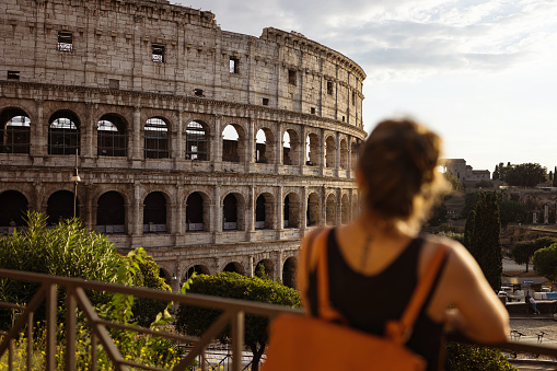 Tourist woman in Rome by the Coliseum: vacations in Italy