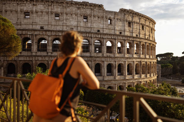 Tourist woman in Rome by the Coliseum: vacations in Italy Tourist woman in Rome by the Coliseum: vacations in Italy colloseum rome stock pictures, royalty-free photos & images