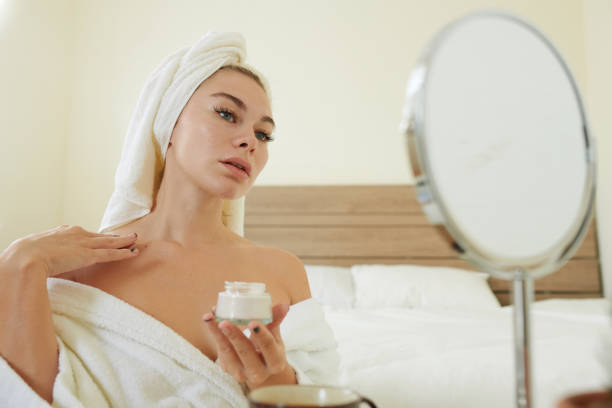 istock Woman Applying Body Lotion on Chest 1366641622