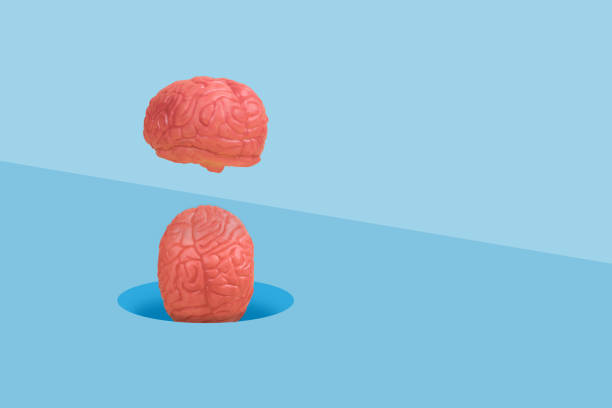 istock Minimal scene with a human brains falling into a hole in the floor. 1366641808