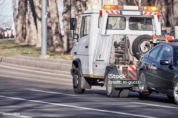 Tow Truck Carrying Improperly Parked Car Or Repossesed Vehicle Stock Photo - Download Image Now