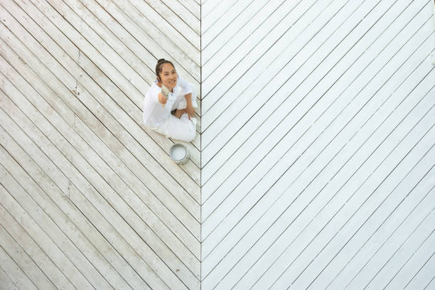 istock Above view smiling asian woman painting deck 1366646820