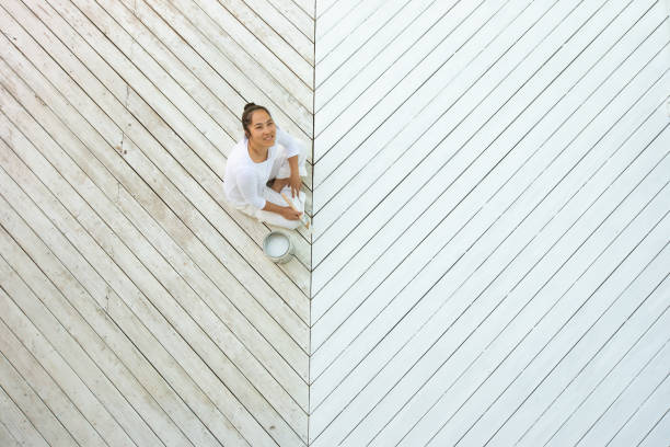 istock Above view smiling asian woman painting deck 1366646842
