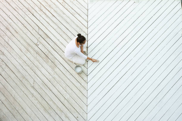 High angle view of asian woman painting deck stock photo