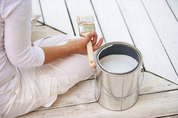 istock Asian woman painting deck 1366646898