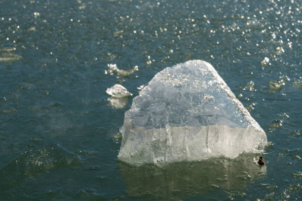 Full frame of frozen lake with ice cubes on top