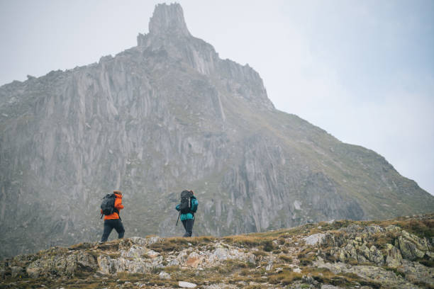 istock Hikers explore mountain ridge in the mist 1366647285