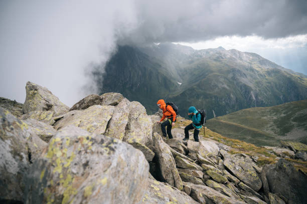 istock Mountaineers scramble up mountain slope 1366647435