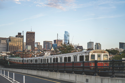 Boston red subway line on the Longfellow Bridge with scenic view of skyscrapers in the background