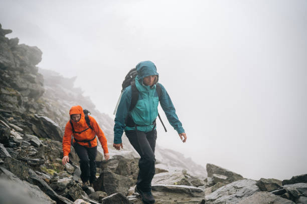 istock Mountaineers scramble up a rocky ridge 1366648167