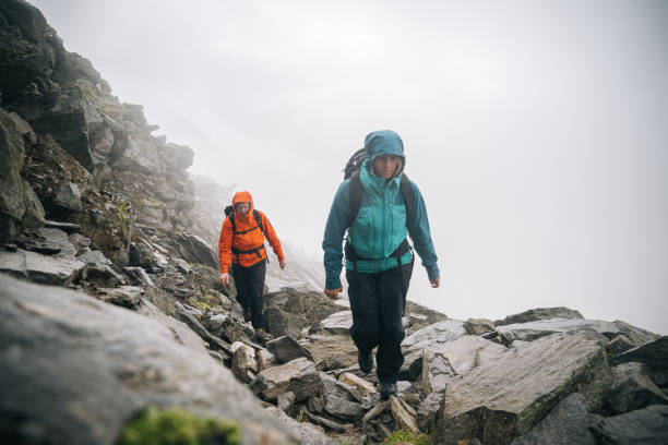 istock Mountaineers scramble up a rocky ridge 1366648227