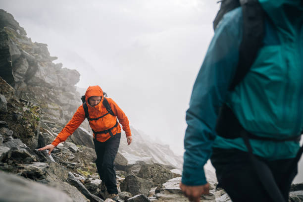 istock Mountaineers scramble up a rocky ridge 1366648302